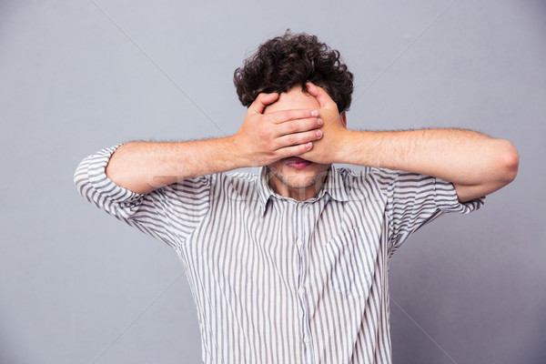 Stock photo: Man covering his eyes 