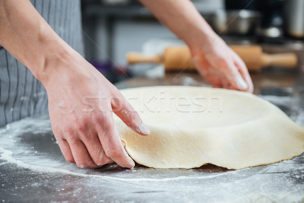 Hands of man preparing pie in baking pan  Stock photo © deandrobot