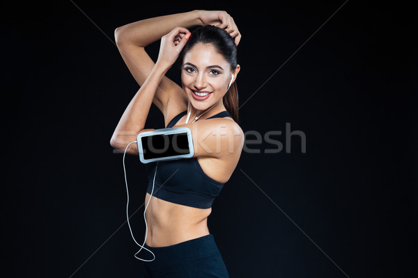 Stockfoto: Glimlachend · fitness · vrouw · luisteren · muziek · hoofdtelefoon · naar