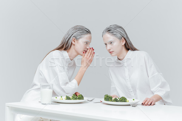 Two girls talking at the table Stock photo © deandrobot