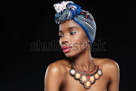 Stock photo: Side view of young african woman on black background