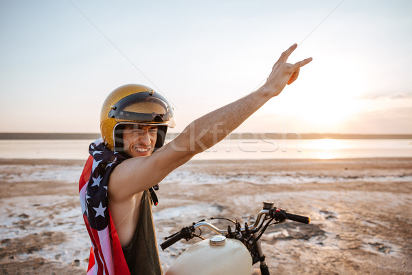 Man in american flag cape with hands up in air Stock photo © deandrobot