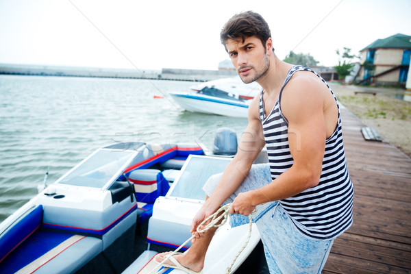 Bonito jovem marinheiro corda pier Foto stock © deandrobot