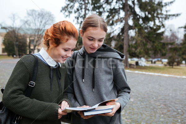Two teenage female students with book outside Stock photo © deandrobot