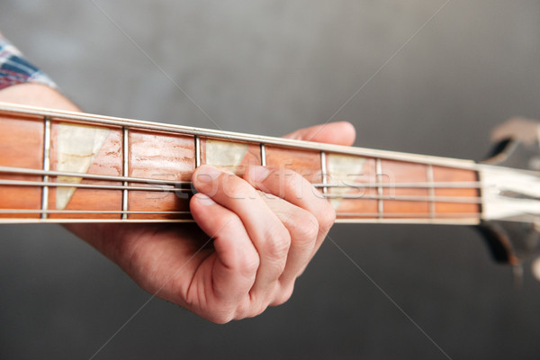 Closeup of man hands playing guitar Stock photo © deandrobot