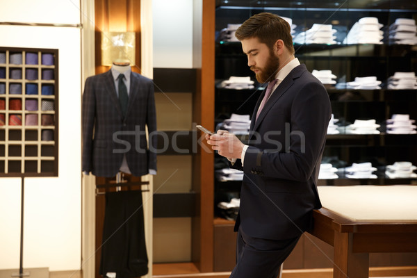 Side view of man using smartphone Stock photo © deandrobot