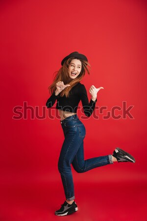 Meglepett ijedt fiatal nő fut ugrik piros Stock fotó © deandrobot