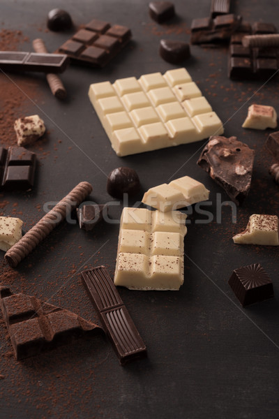 Big variety of chocolate bars crashed into pieces Stock photo © deandrobot