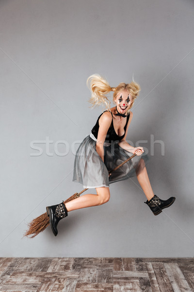 Full length portrait of a laughing crazy blonde woman Stock photo © deandrobot