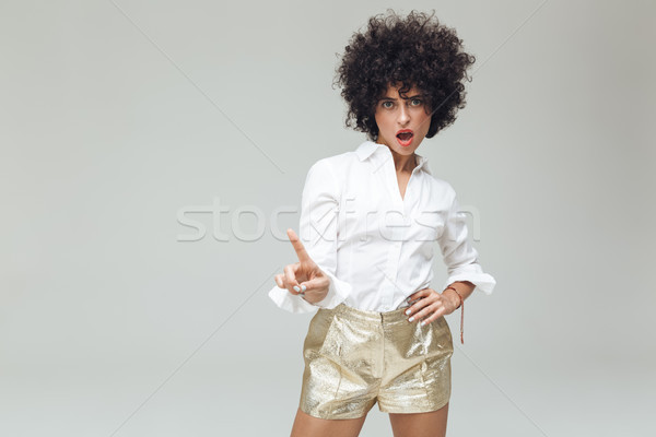 Serious retro woman dressed in shirt standing isolated Stock photo © deandrobot