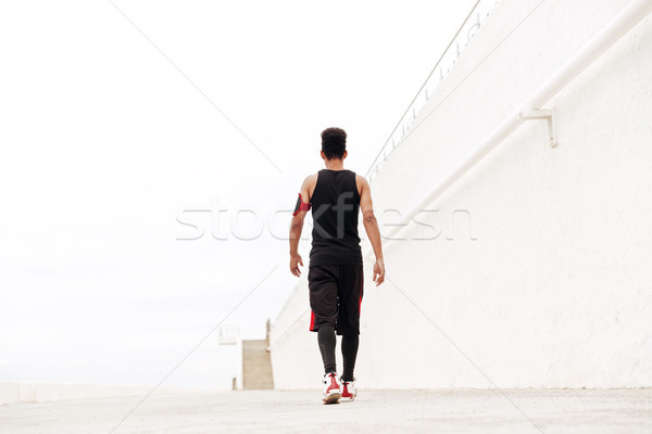 Back view image of young african sports man Stock photo © deandrobot