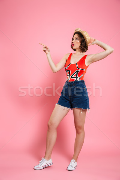 Full length portrait of amazed young woman in red bodysuit and j Stock photo © deandrobot