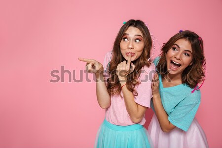 Two cute girls dressed in colorful clothes touching with fingers Stock photo © deandrobot