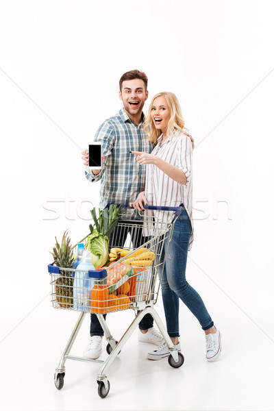 Full length portrait of a happy couple Stock photo © deandrobot
