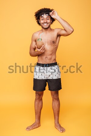 Full length image of Cheerful screaming naked man in shorts Stock photo © deandrobot