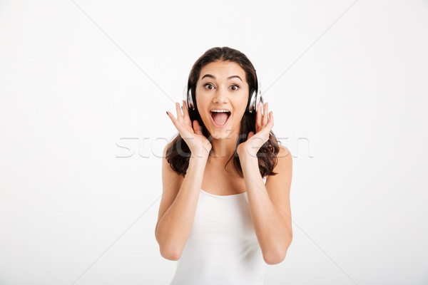 Portrait of an excited girl dressed in tank-top Stock photo © deandrobot