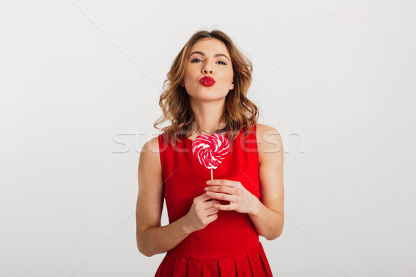 Stock photo: Portrait of a cute young woman dressed in red dress