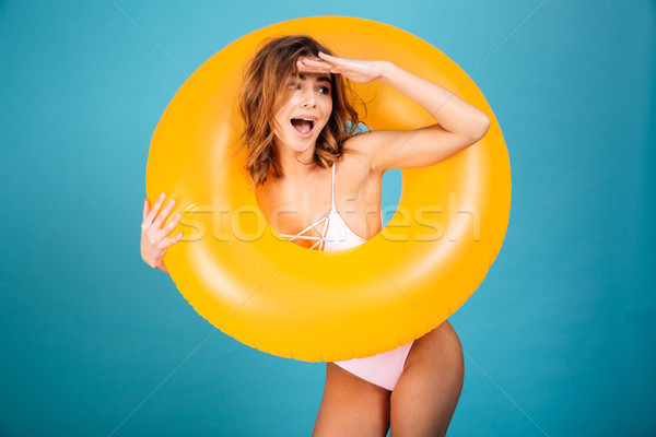 Portrait of a cheerful girl dressed in swimsuit Stock photo © deandrobot
