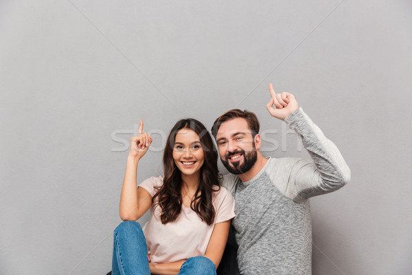 Stock photo: Portrait of a cheerful young couple hugging