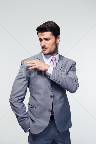 Businessman shakes off something from his shoulder  Stock photo © deandrobot