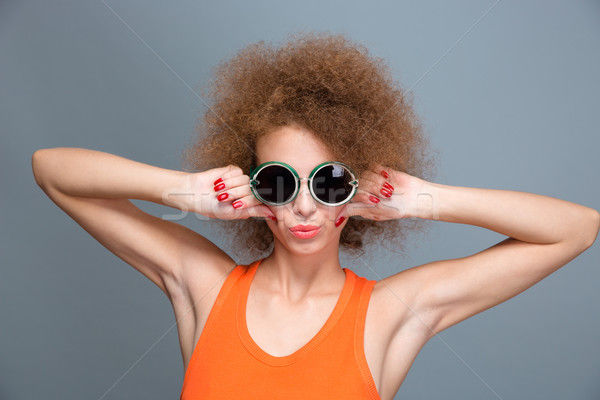 Cool confident young female posing and making grimace Stock photo © deandrobot