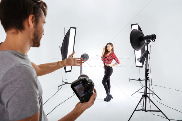Photographer shooting model in studio Stock photo © deandrobot