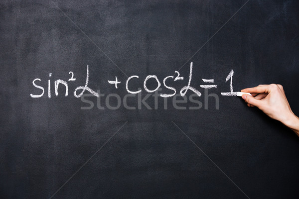 Hand writing trigonometry formula on blackboard  Stock photo © deandrobot