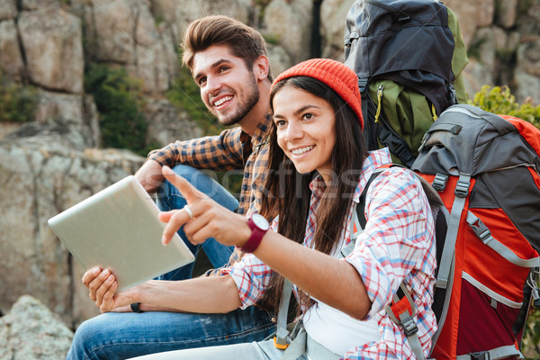 Young adventure couple with tablet Stock photo © deandrobot