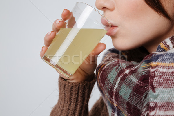 Cropped image of sick young lady drinking medicine Stock photo © deandrobot