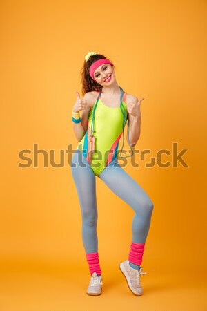 Sad astonished sportswoman standing and measuring her waist with tape Stock photo © deandrobot