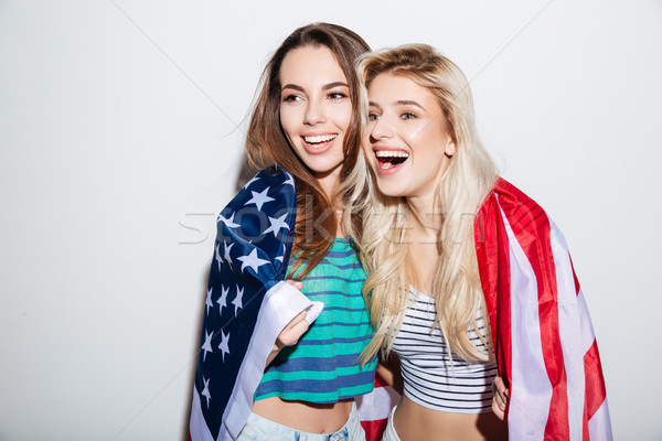 Portrait of american women carrying usa flag on their shoulders Stock photo © deandrobot
