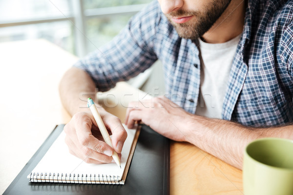 Cropped photo of young man in office coworking Stock photo © deandrobot
