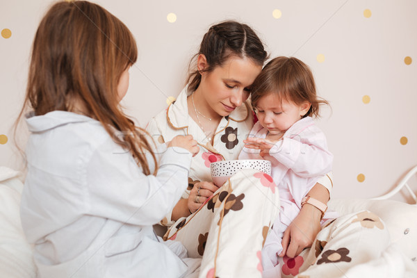 Mother with daughters in nursery Stock photo © deandrobot