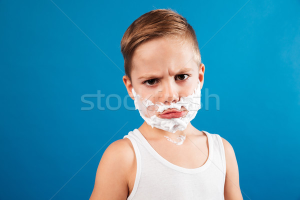 Displeased serious young boy in shaving foam like man Stock photo © deandrobot