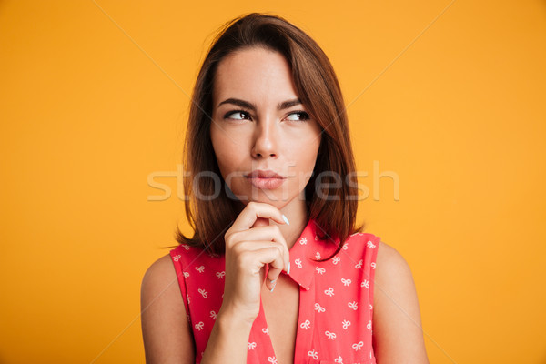 Close-up shot of beautiful thinking woman in red dress, looking  Stock photo © deandrobot