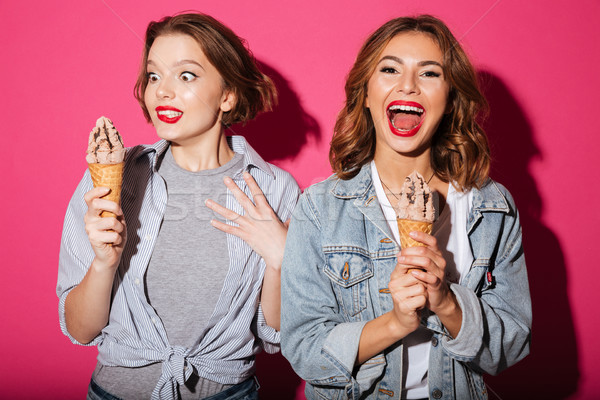 Funny two women friends standing isolated Stock photo © deandrobot