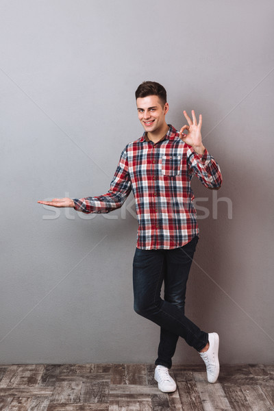 Full length image of Smiling man in shirt and jeans Stock photo © deandrobot