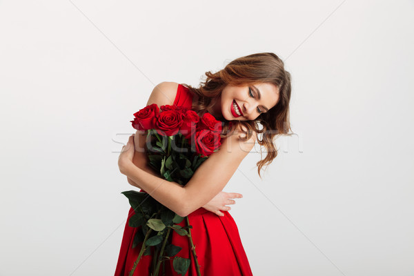 Ritratto attrattivo vestito rosso bouquet Foto d'archivio © deandrobot