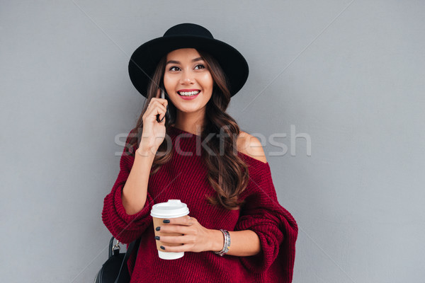Stock photo: Portrait of a smiling cheerful asian girl dressed in hat