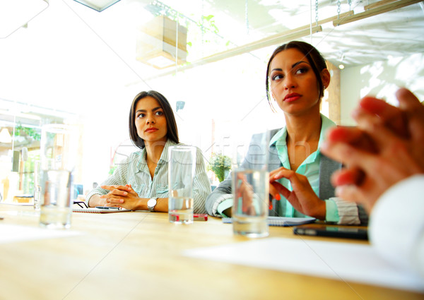 Businesspeople sitting at the table during a meeting in office Stock photo © deandrobot