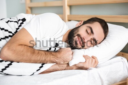 Sleepy woman looking at alarm clock alarm in the bed Stock photo © deandrobot