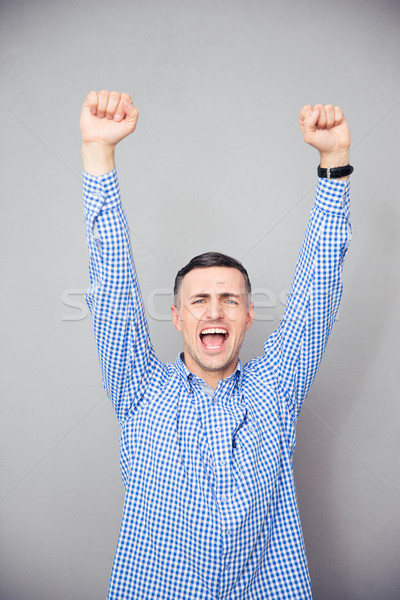 Homem as mãos levantadas para cima vitória gesto Foto stock © deandrobot