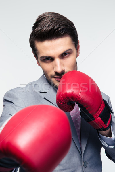 Businessman ready to fight with boxing gloves  Stock photo © deandrobot