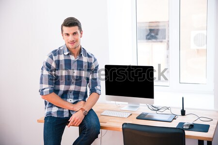 Stock photo: Happy businessman sitting on the table