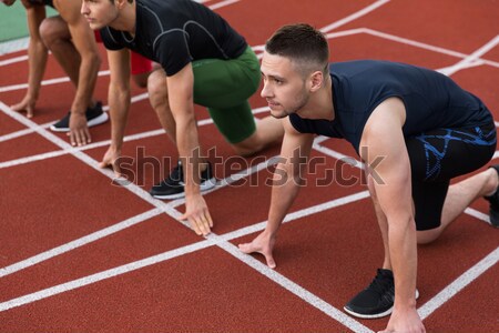 Woman warming up at stadium Stock photo © deandrobot