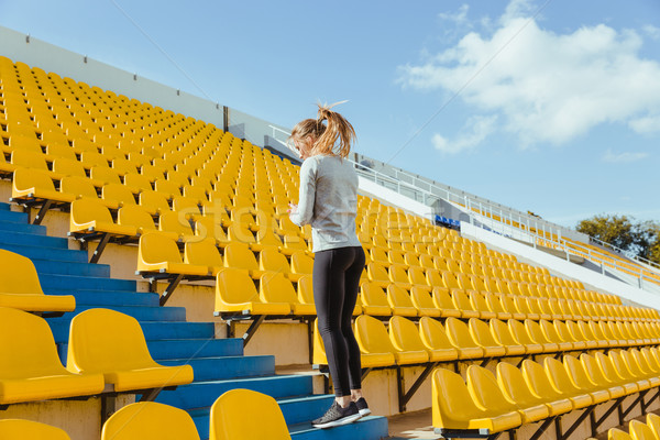 Sports woman doing warm up exercises Stock photo © deandrobot