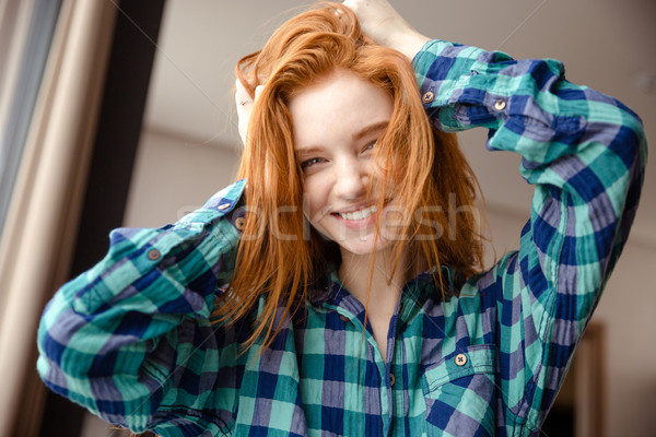 Amusing funny girl in checkered shirt with tousled red hair Stock photo © deandrobot