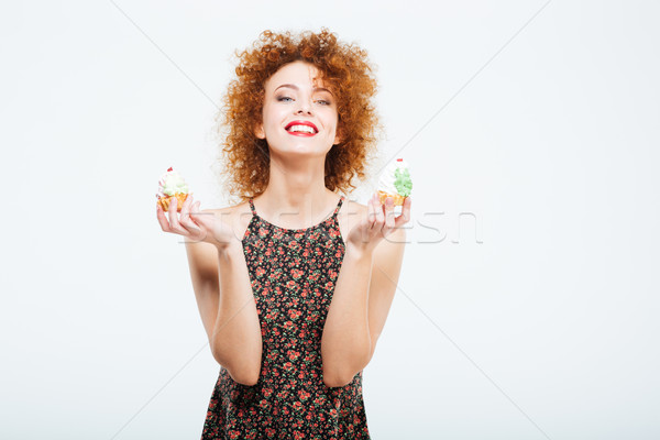 Happy redhead woman holding cakes Stock photo © deandrobot