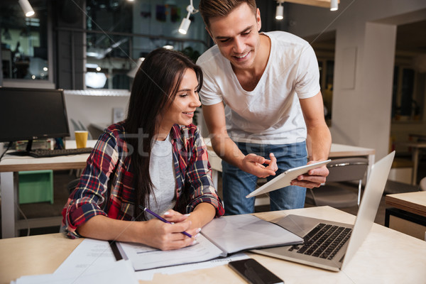 Coworkers work with documents by the table Stock photo © deandrobot