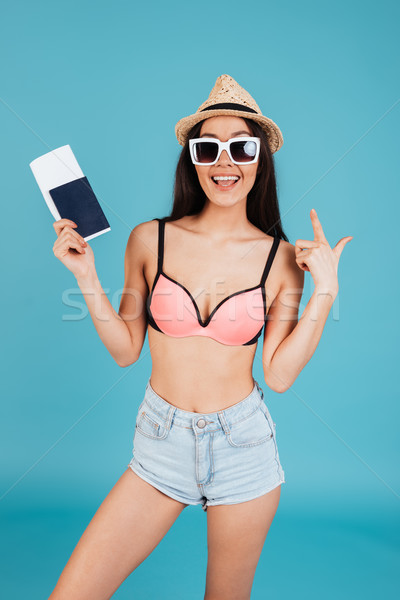 Young lady with long hair posing over blue background Stock photo © deandrobot
